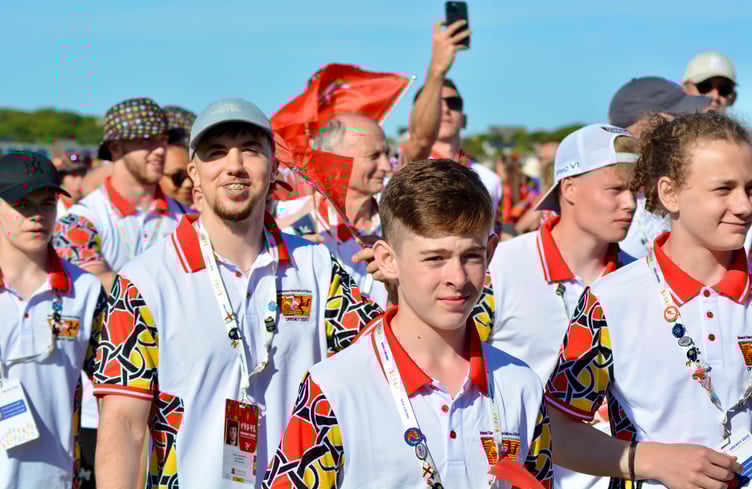 Manx gymnasts Ewan McIlraith (grey cap) and Harry Eyres (white cap) - pictured here during Saturday's opening ceremony - were both in the medals at the Island Games on Monday (Photo: Andy Dalrymple)