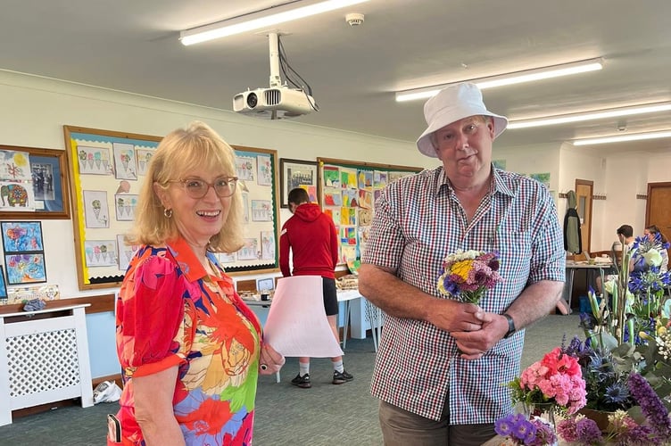 Esteemed judges visited the Millennium Hall on Sunday morning to choose the winners in various classes of the art and produce show. Pictured is MMPF Treasurer Gill Eaton with fruit and vegetable judge Mr Bryan Radcliffe of Bry Rad's in Ramsey