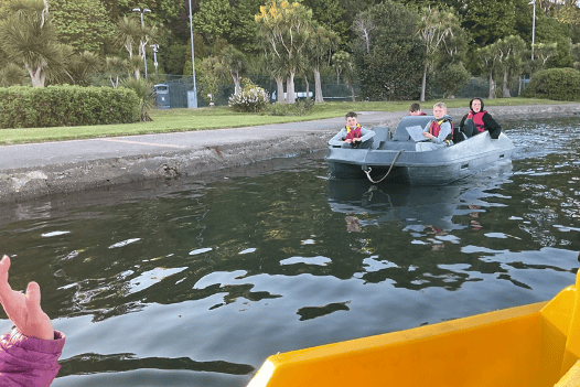 A group of boys navigate to an orienteering marker on Mooragh Park Lake.