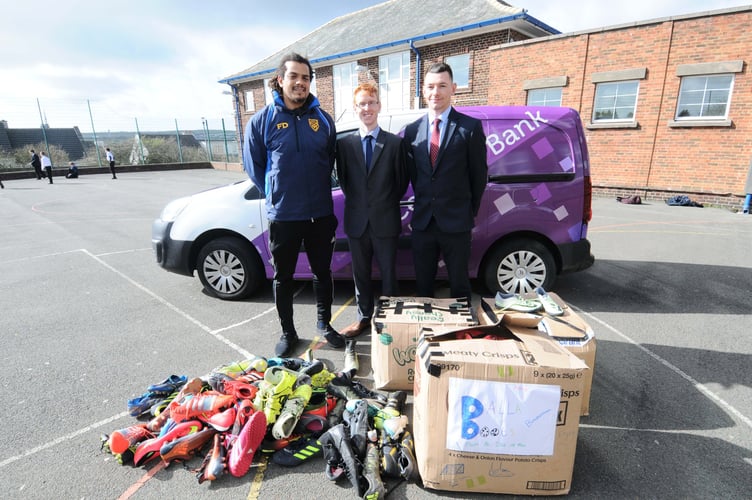 Balla Boots, an initiative run by St George's footballer and Ballakermeen High School teacher Furo Davies (left), is donating pairs of 300 football boots to Nigeria - pictured with Conister Bank's Tom Charmer and Lee Gale