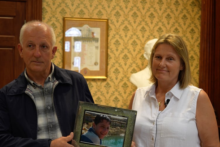 Daniel Boyde's parents Mark Boyde and Diane Taylor with a portrait of their son