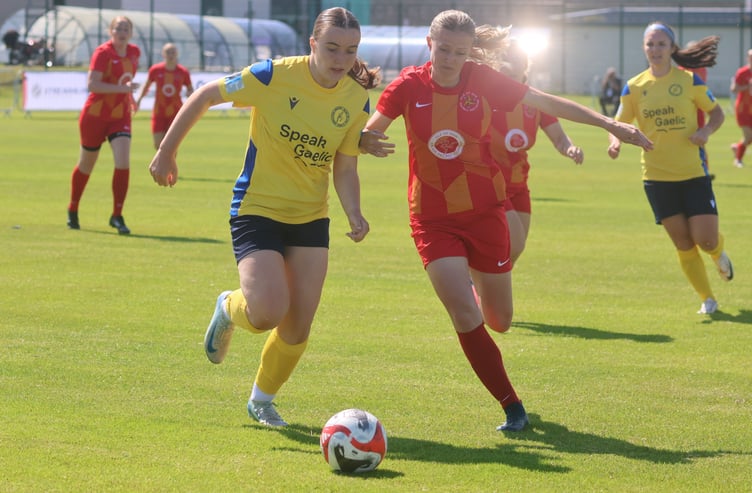 The Isle of Man's Louise Gibbins (right) competes with a Western Isles opponent for the ball during Thursday's semi-final clash at Kirkwall (Photo: Paul Hatton)