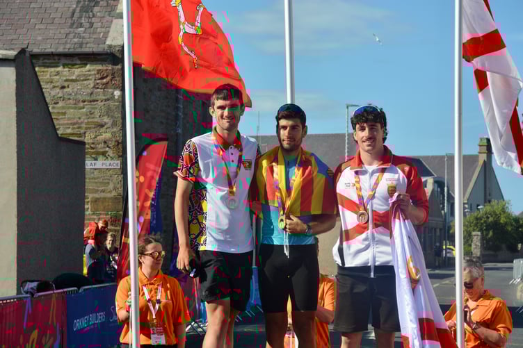 Tyler Hannay (left) on the town crit podium with Menorca's Aaron Genestar Sánchez and Jersey's Jacob Mauger (right)