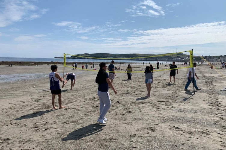 People enjoying a game of volleyball during Douglas Beach day