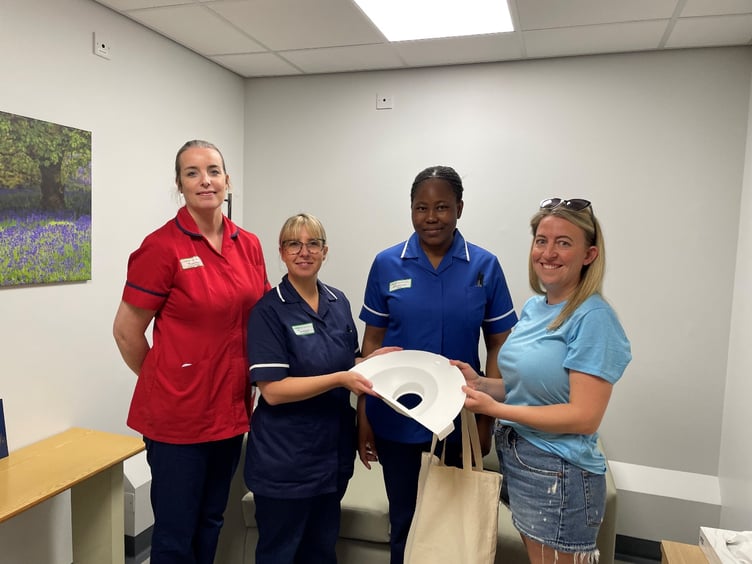 Vicky Christian (Arlo’s Adventure) hands over miscarriage collection packs to (L-R) Regan Baggley, Head of Midwifery, Jody Brannon, Senior Sister, and Monica Awolwarimtu, Registered Nurse, in the year-old Bluebell Suite sanctuary