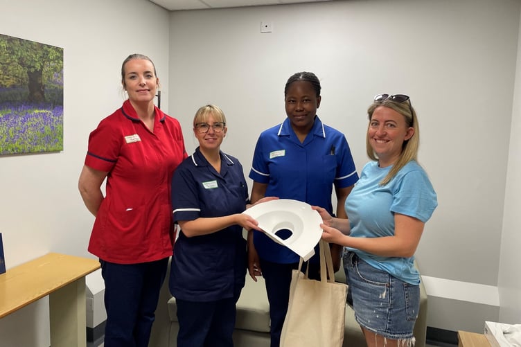 Vicky Christian (Arlo’s Adventure) hands over miscarriage collection packs to (L-R) Regan Baggley, Head of Midwifery, Jody Brannon, Senior Sister, and Monica Awolwarimtu, Registered Nurse, in the year-old Bluebell Suite sanctuary