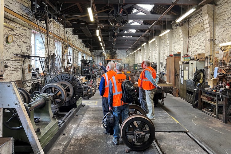 Enthusiasts are given a tour of the workshops at Douglas railway station