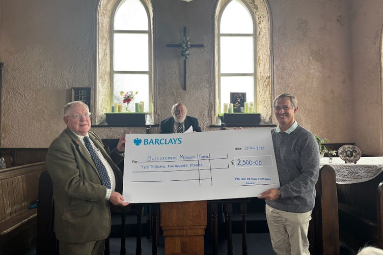 Members of the Victorian Society handing a cheque over to Ballakilpheric chapel