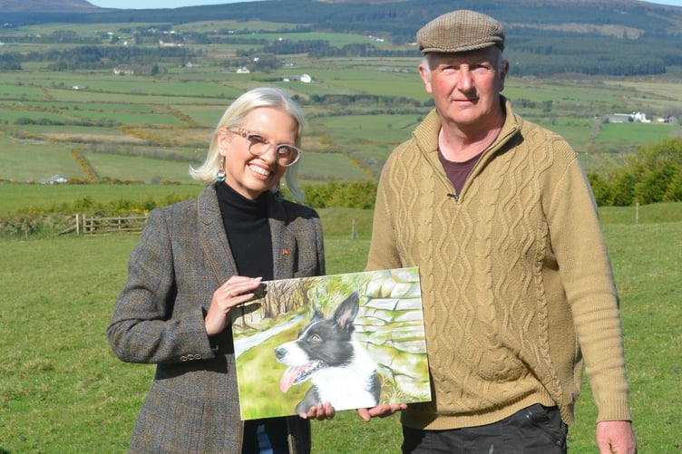 Yolande Alberts with Ian Kelly. A painting of Ian's dog Bella is one of the stamps