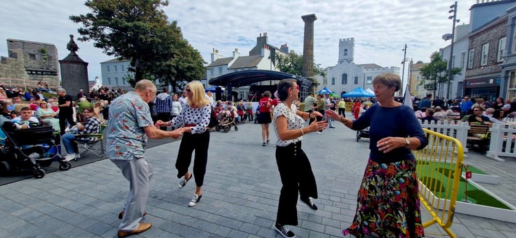 Attendees at Castletown Festival dancing inside the Market Square