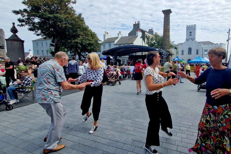 Attendees at Castletown Festival dancing inside the Market Square