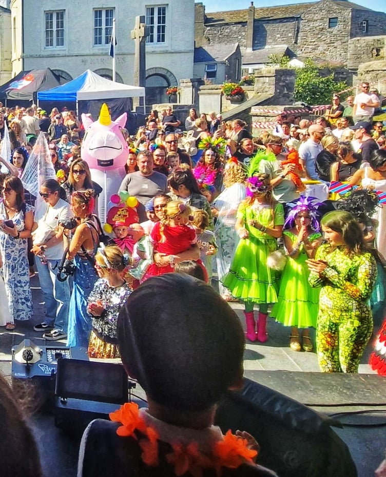 Crowds inside the Market Square - with plenty of fancy dress - look on at the entertainment on stage