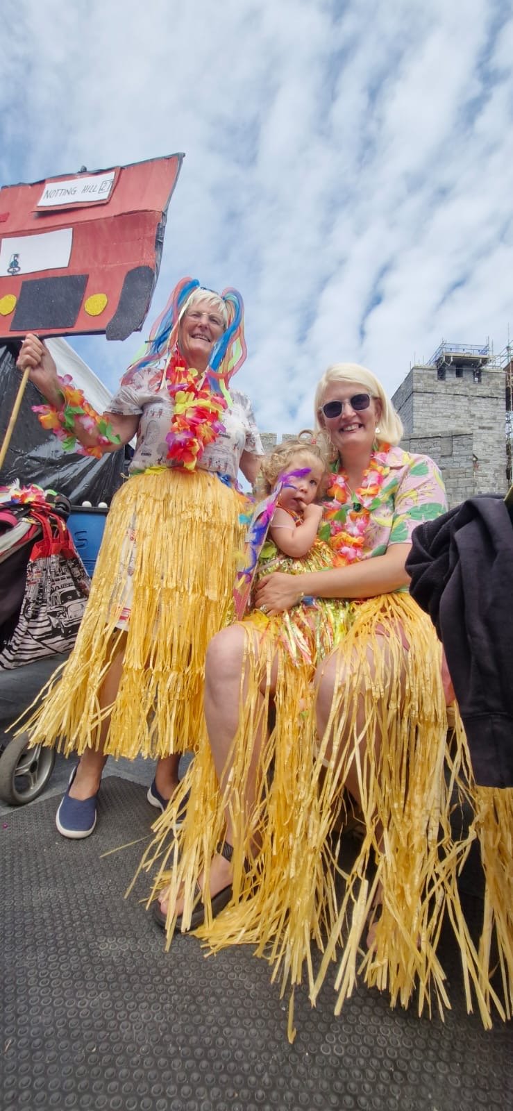 Different generations dressed in Hawaiian-style skirts