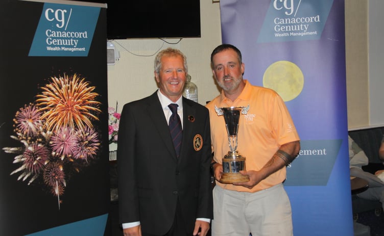 Castletown Golf Club's Ross Mulligan (right) receives the Scratch League trophy from Isle of Man Golf president Gary Ashe