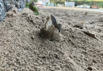 Commissioners at a loss after broken glass bottles left on village beach