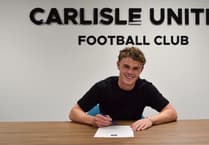 Former Peel midfielder signs first professional contract at League Two outfit