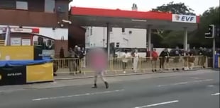Spectator filmed crossing closed course seconds before bike races past