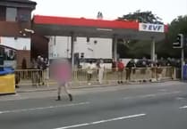 Spectator filmed crossing closed course just seconds before bike races past