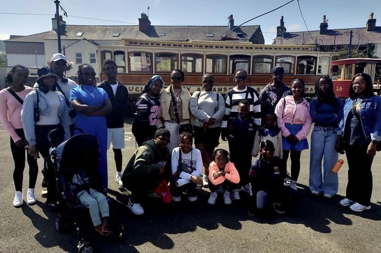 The ‘Umu-Love' family from Nigeria enjoying a trip on the electric tram