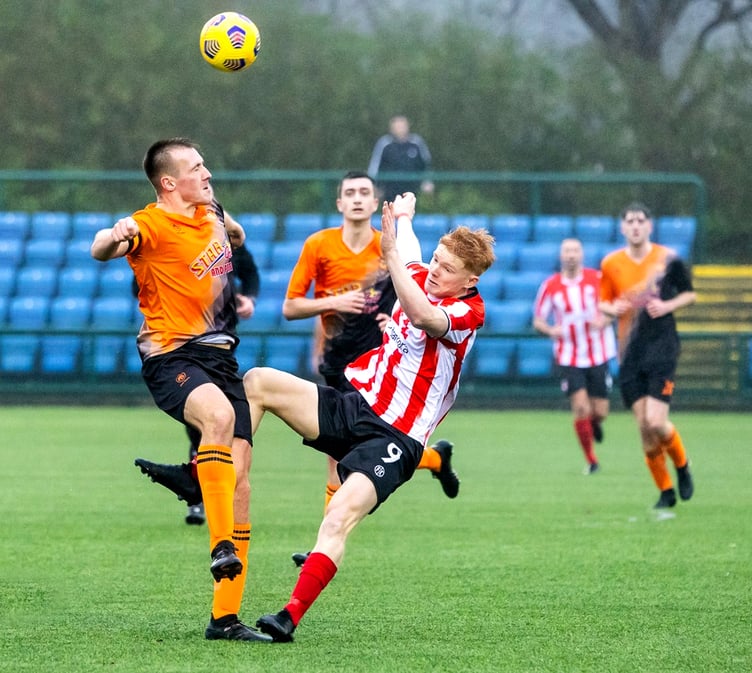 Ayre United's Jamie Callister (left) and Peel's Tomas Brown battle for the ball during one of the two sides' meetings last season (Photo: Gary Weightman)