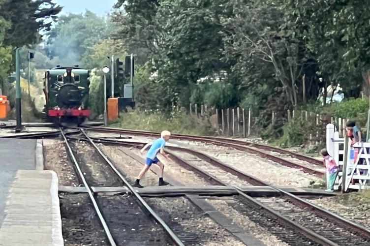 The boy finally gets off the track as the loco passes the Droghadfayle Road crossing