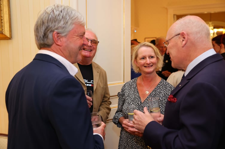 Manx Motor Cycle Club vice president and travelling marshal Jim Hunter with his wife Karen chat to Lieutenant Governor Sir John Lorimer