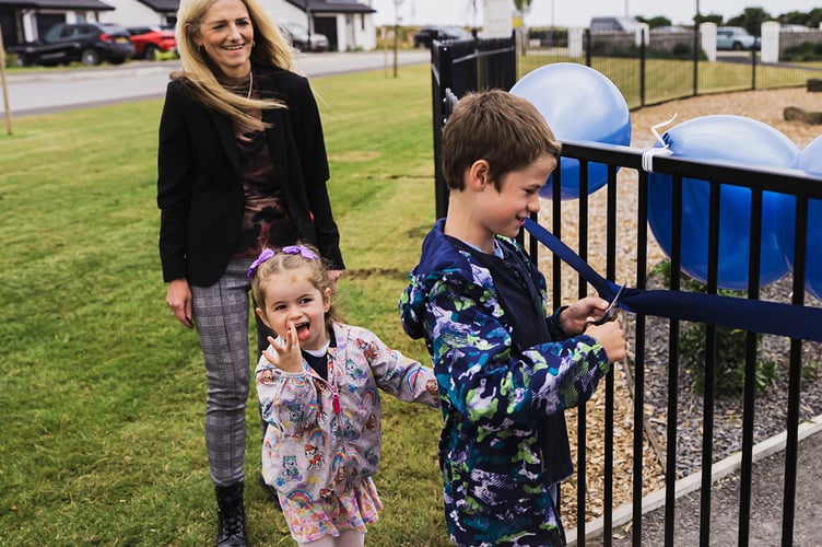 Youngsters Frank and Beryl cut the ribbon to officially open Jurby's new 'natural play park'