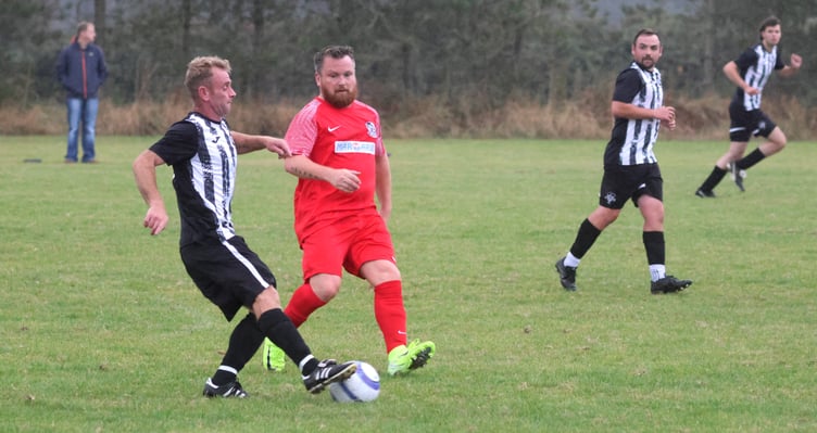 Colby's Ciaran Brown (left) attempts to play the ball under pressure from Governor's Athletic's Robert Bell during the two sides' 2-2 draw on Wednesday evening (Photo: Paul Hatton)