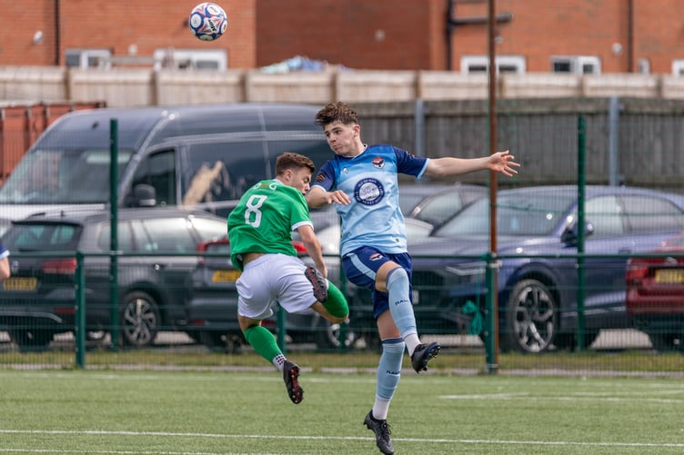 FC Isle of Man's Callum Hudgeon heads clear from a Burscough opponent during Saturday's match in Ormskirk (Photo: Hannah McHugh)