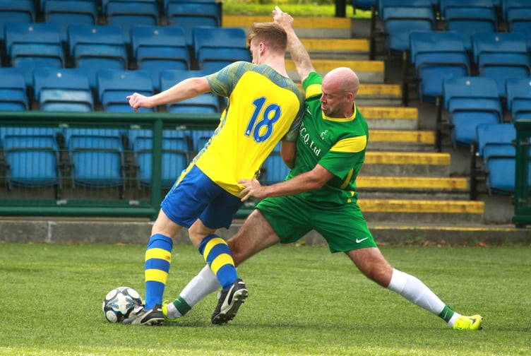 St Mary's striker Mark Wolfenden challenges Onchan's James Leece during the weekend's clash at the national stadium (Photo: Dave Norton)