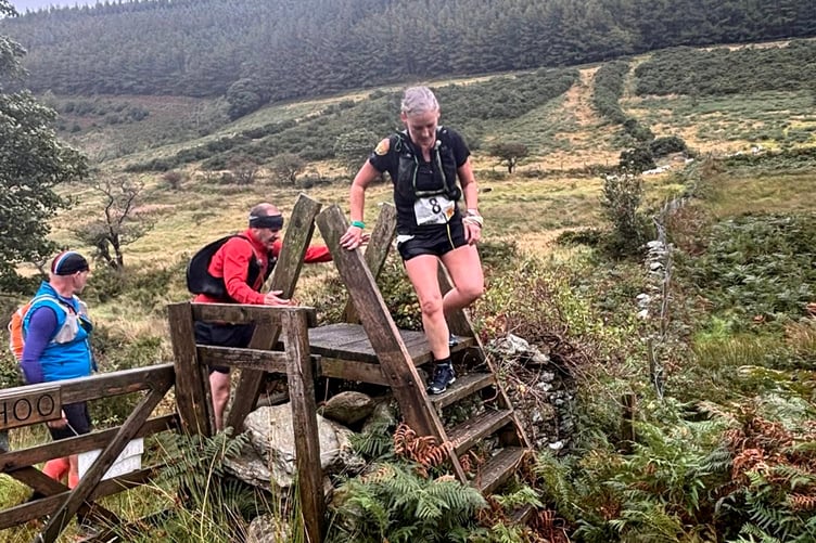 Carol Brogan navigates one of the stiles on her way to claiming the women's honours in the Ellan Vannin Fell Race last weekend (Photo: David Hodgson)