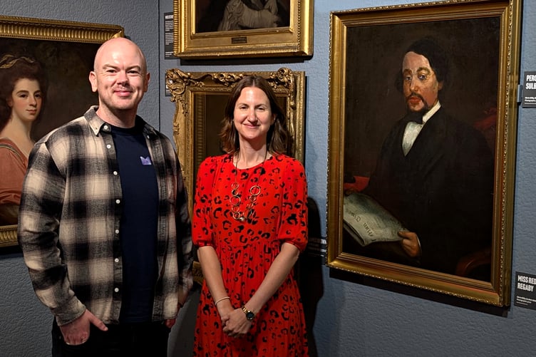 Media Isle of Man editor Dion Jones with Manx National Heritage's Curator of Art & Social History beside the portrait at the Manx Museum