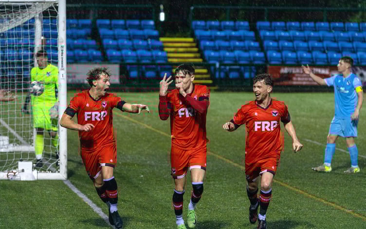 Charlie Higgins (centre) celebrates his hat-trick goal which sealed a dramatic 3-2 victory for FC Isle of Man against Charnock Richard at the Bowl on Saturday evening (Photo: Hannah McHugh)