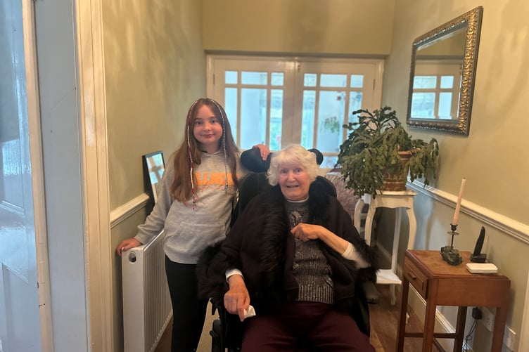 Lynsey Clague's mum Helen pictured in her specialist wheelchair with one of her grandchildren and carers, Alice, aged 10