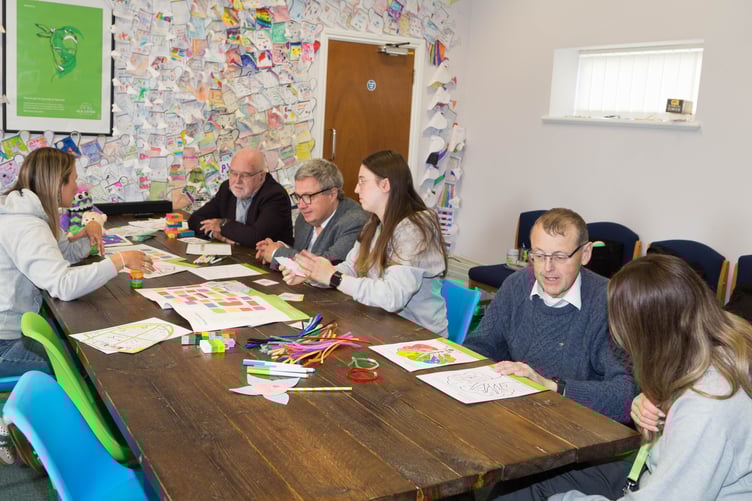 Representatives from the Masons experience the special educational aids and techniques which are to be used by Isle Listen in a new project funded by the Masonic Charitable Foundation. From left: well-being facilitators Kirsty Arnold, Erin Callow and Holly Ramsay teaching membership officer John Kermode, charity officer Helmut Kessler and Head of Isle of Man Freemasonry Martin Blackburn (Picture by Fatfriar Productions)