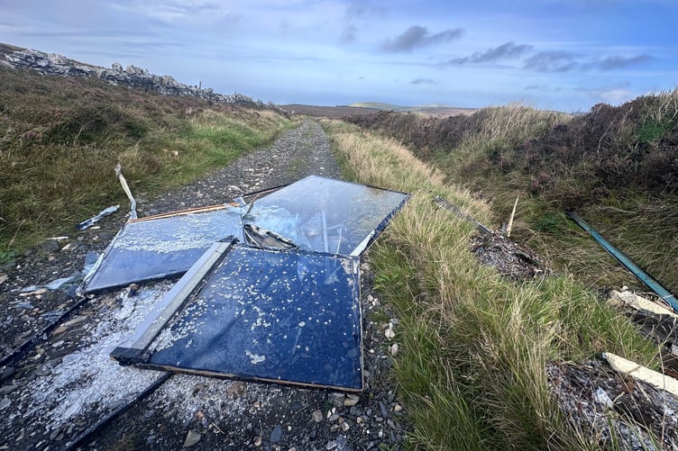 Broken glass panels fly-tipped on greenway near Round Table Road