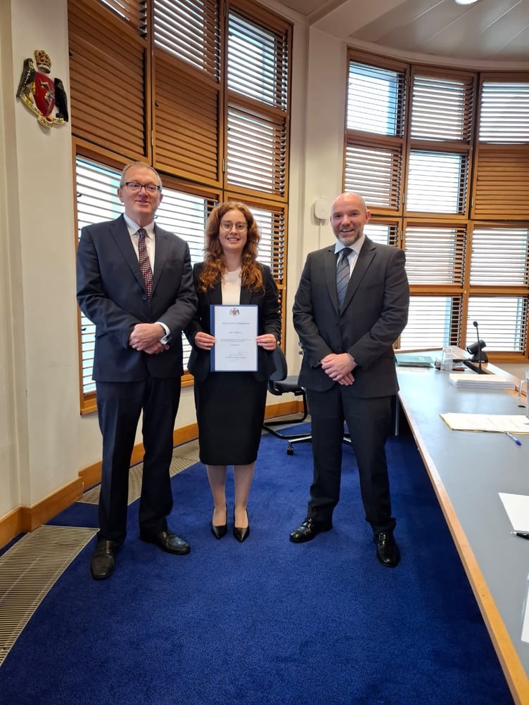 Emily Morton with First Deemster Andrew Corlett and Simcocks director Alex Spencer (right)