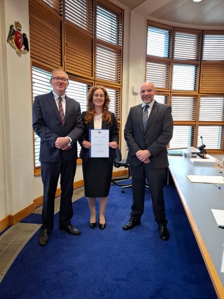 Emily Morton with First Deemster Andrew Corlett and Simcocks director Alex Spencer (right)