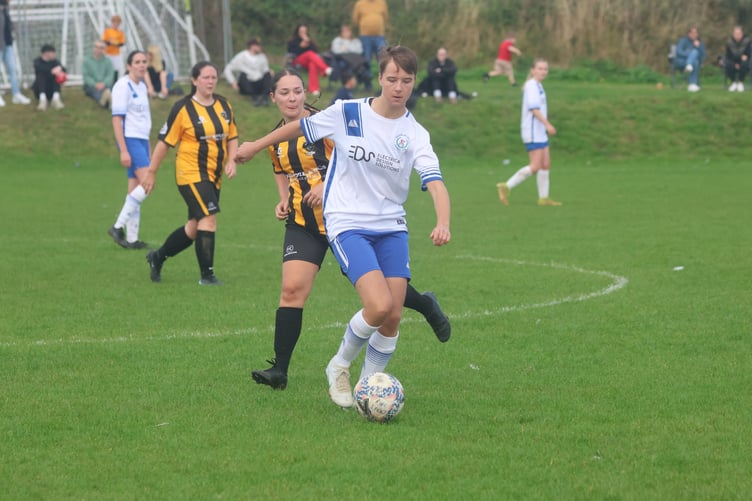 Douglas Royal's Holly Robinson tries to evade the attentions of Rushen United's Chloe Venus at Croit Lowey on Sunday (Photo: Paul Hatton)