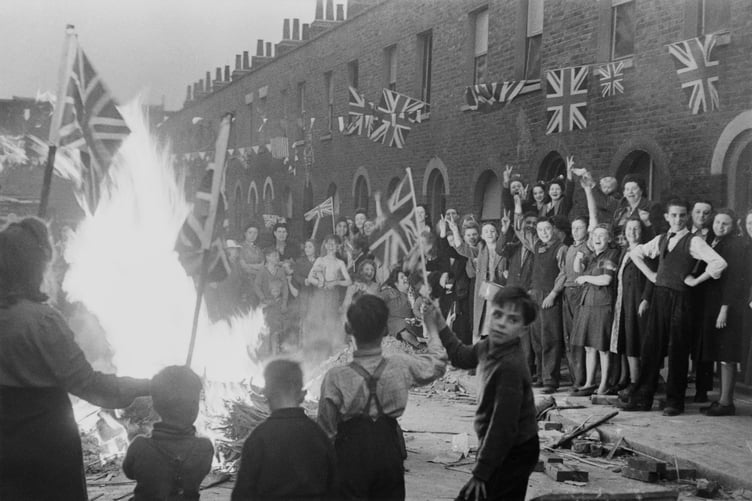 Residents of a bombed London street celebrating VE Day, caught on film by Leonard McCombe. (Courtesy of the McCombe family)