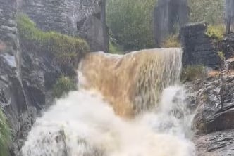 The heavy downpours on Friday afternoon has turned the waterfall below The Laxey Wheel into a torrent