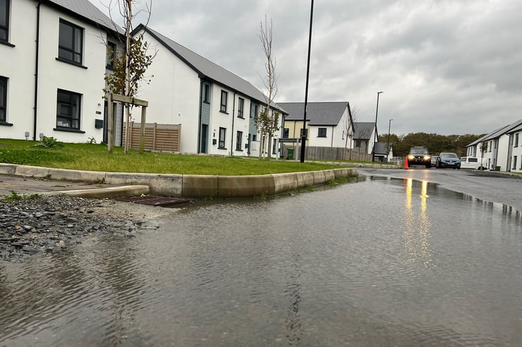 Flooding on unfinished section of road at Railway Court, The Meadows