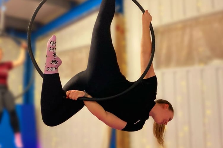 A student in an aerial hoop class