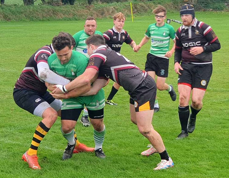 A Southern Nomads player is tackled by two Western Vikings opponents during Saturday's Manx Shield clash
