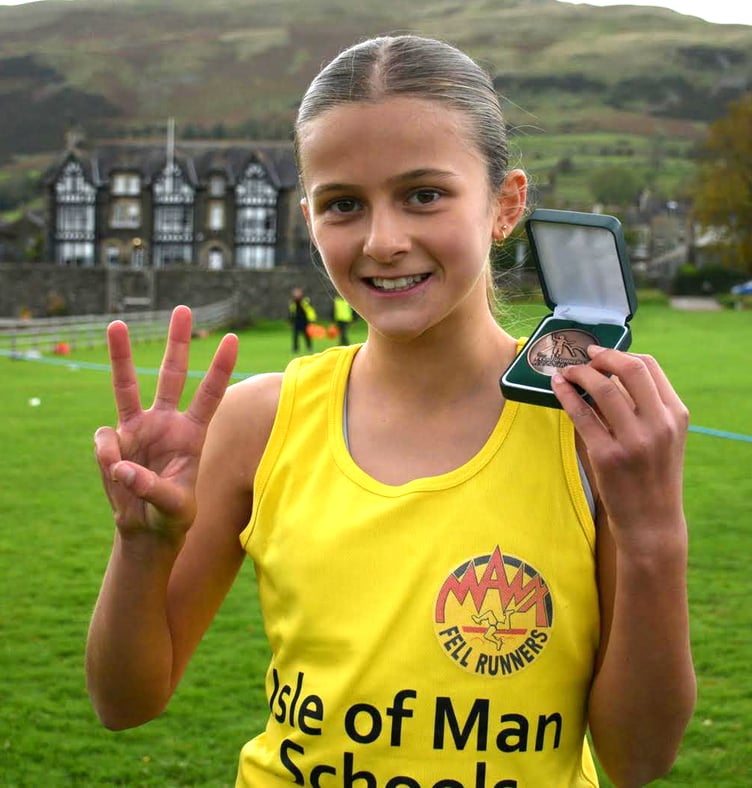 Maisy-Jo Faragher with her bronze medal after finishing third in the year 7 race at the English Schools Fell Running Championships in Sedbergh last weekend (Photo: Dave Woodhead/woodentops.org.uk)