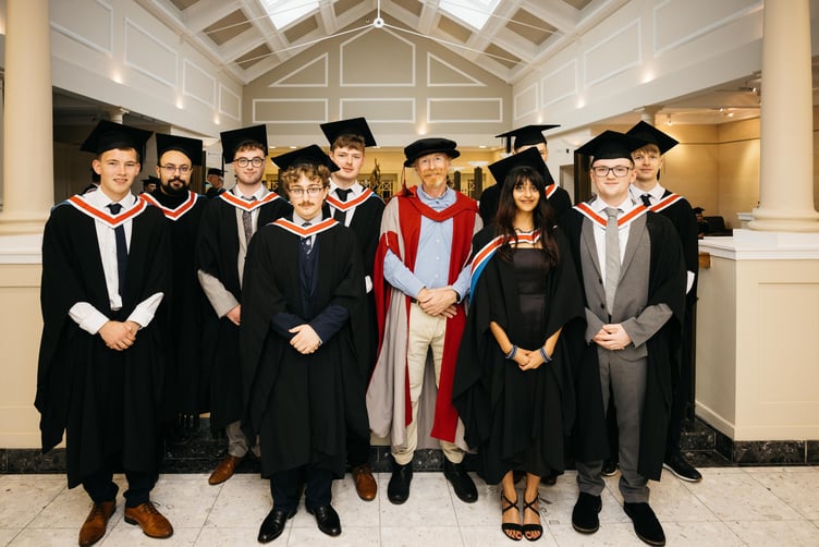 Lecturer Dr Alistair Robertson with Computer Science graduates