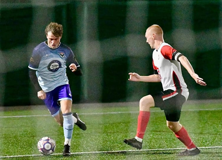 Dean Pinnington (left) goes up against a South Liverpool opponent during the two sides' Premier Division clash in the North West Counties Football League on Wednesday evening (Photo: Mike Shaw)