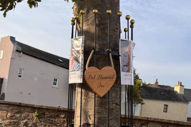 The memorial tree in the grounds of St Peter’s Church in Peel features plenty of hooks where people in the west can hang photos and mementoes in memory of loved ones.