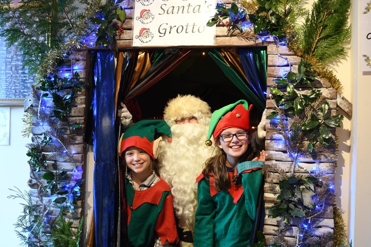 A previous Laxey Christmas markets - Santa with elves Saskia and Izzy