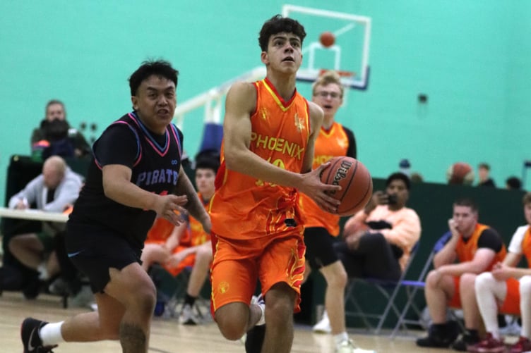 Rishi Chandilya goes to the hoop for Phoenix past the defence of Pirates' Neil Domingo during Thursday's meeting at the NSC (Photo: Martin Dunne)